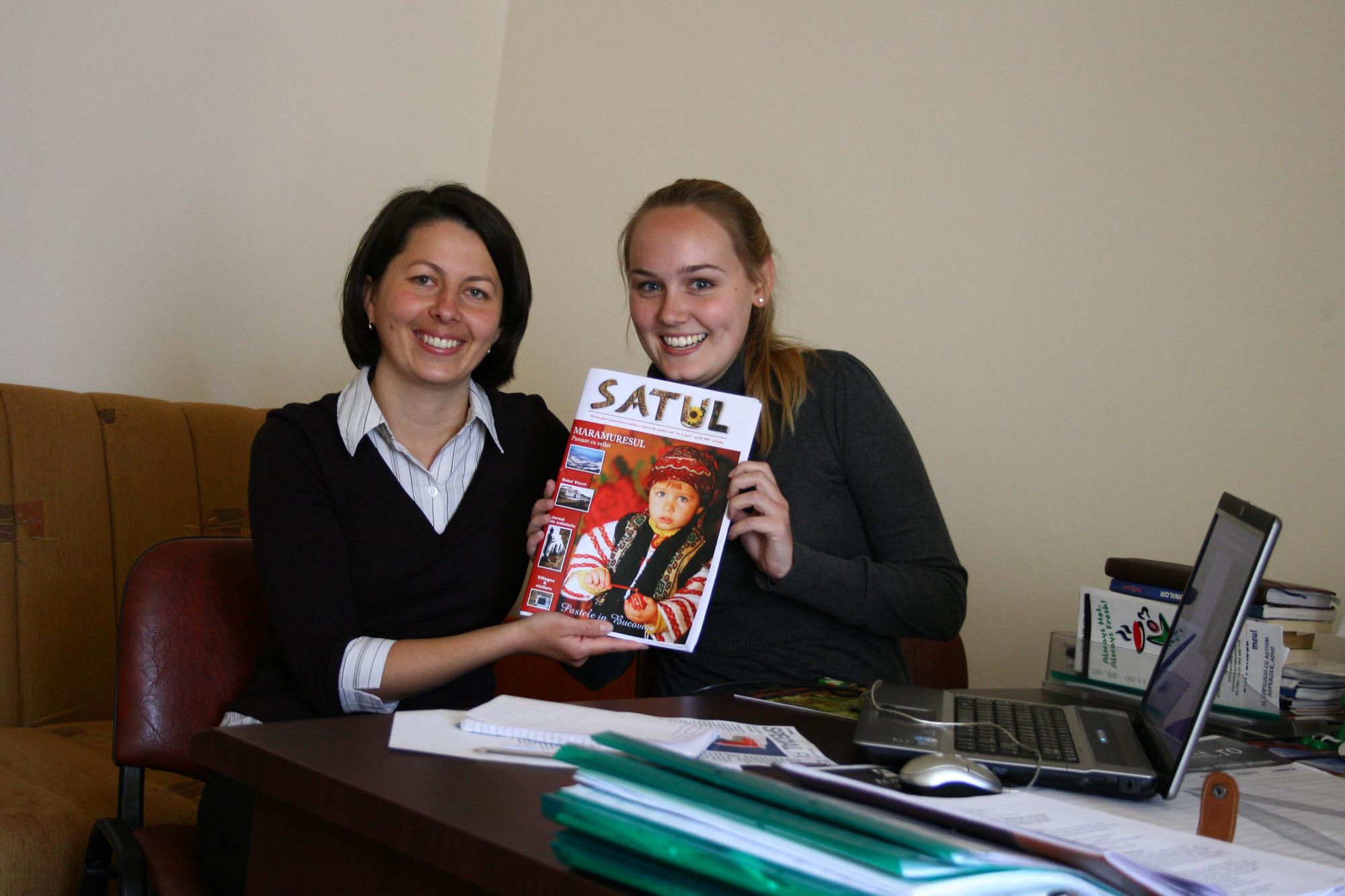 A Projects Abroad journalism intern with her supervisor in Romania An intern holds up a magazine at a journalism placement in Romania